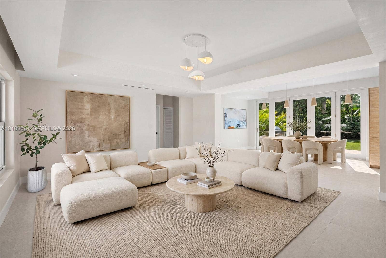 864 NE 91st Terrace, Miami Shores, FL 33138 Virtually Staged: Tray ceiling, large-format tile flooring, multi-pane glass doors, and contemporary pendant lighting