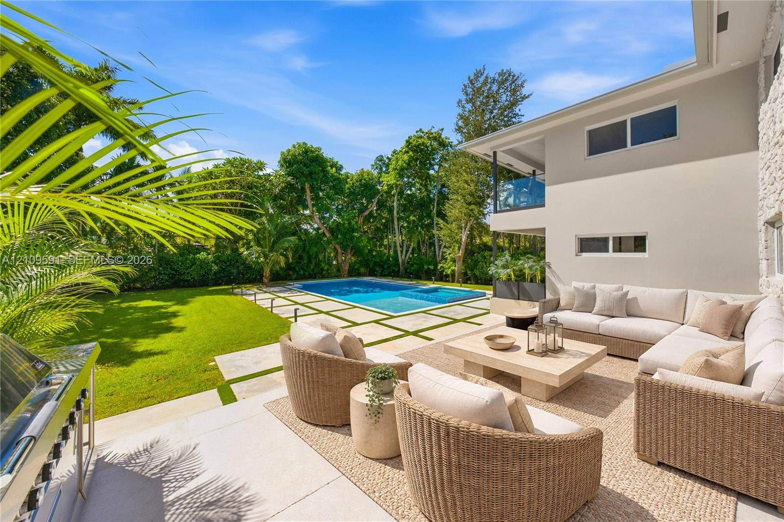 864 NE 91st Terrace, Miami Shores, FL 33138 Virtually Staged: Outdoor living area featuring a paved patio, swimming pool with integrated spa, manicured lawn, and built-in stainless steel grill