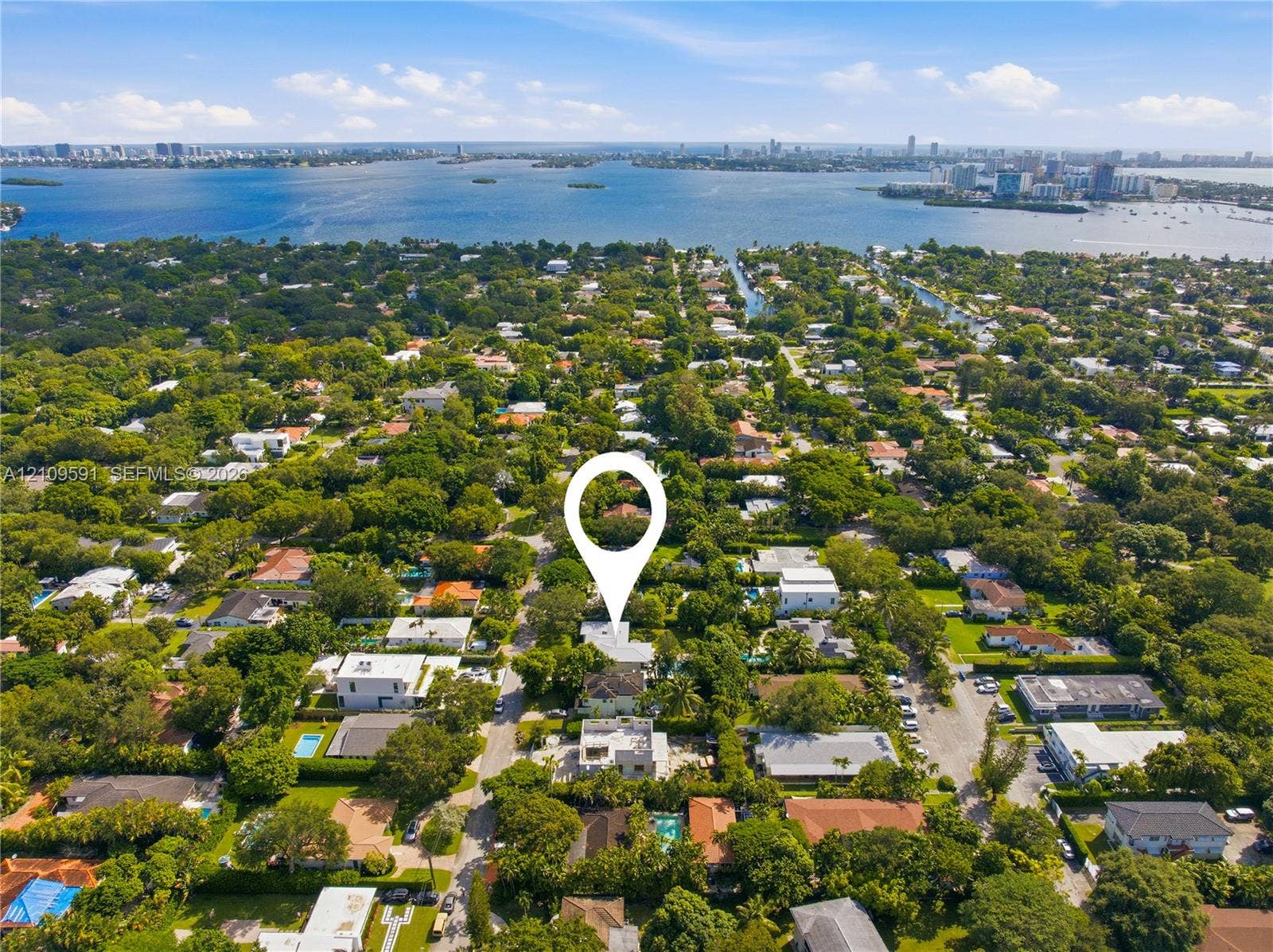 864 NE 91st Terrace, Miami Shores, FL 33138 Aerial perspective of a property featuring mature landscape, extensive tree canopy coverage, and proximity to the coastal bay