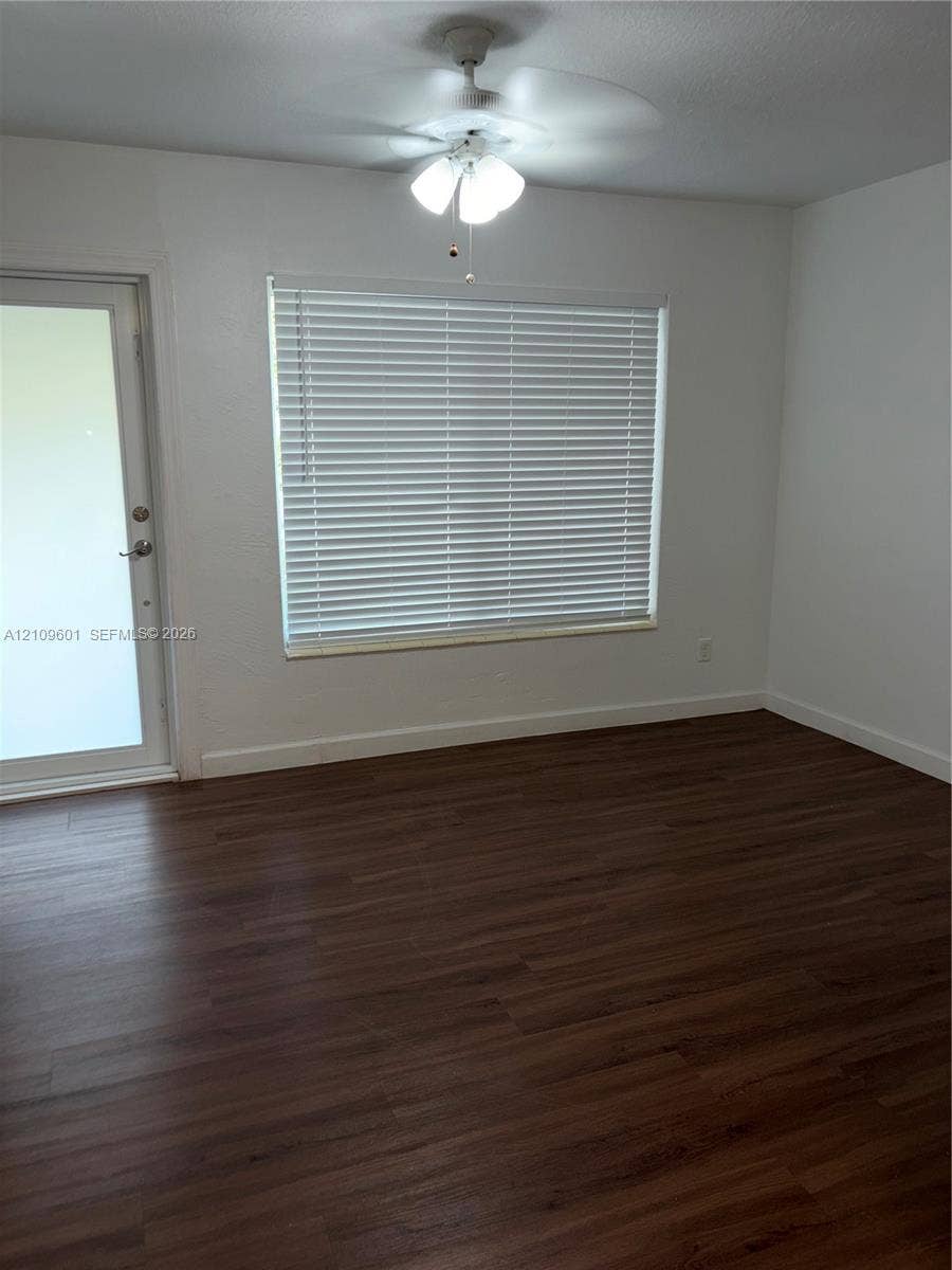 6320 Cleveland Street, Hollywood, Hollywood, FL 33024 Wood-finish flooring, white walls, ceiling fan with light fixture, window with horizontal blinds, and glass-paneled exterior door