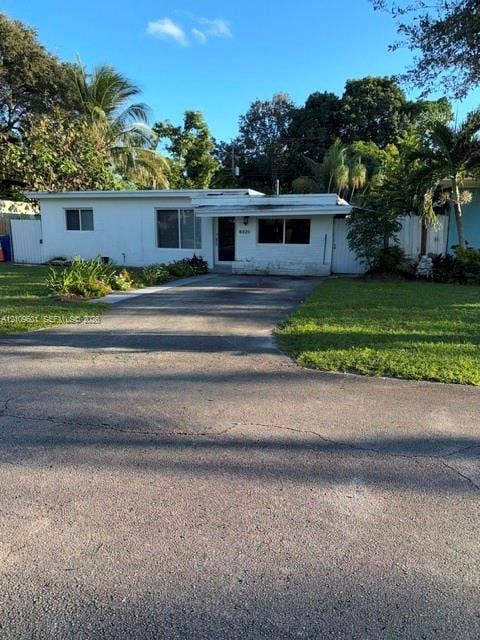 6320 Cleveland Street, Hollywood, Hollywood, FL 33024 Single-story residence featuring a white stucco exterior, concrete driveway, and mature landscaping