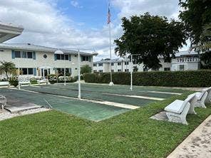1851 NE 62nd Street, #610, Fort Lauderdale, FL 33308 Outdoor shuffleboard courts featuring a paved surface, permanent net stanchions, and surrounding concrete benches