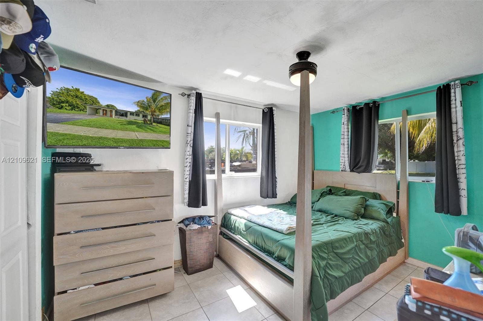 231 SW 64th Way, Pembroke Pines, FL 33023 Bedroom featuring tile flooring, dual-aspect windows, and a ceiling fan with integrated lighting