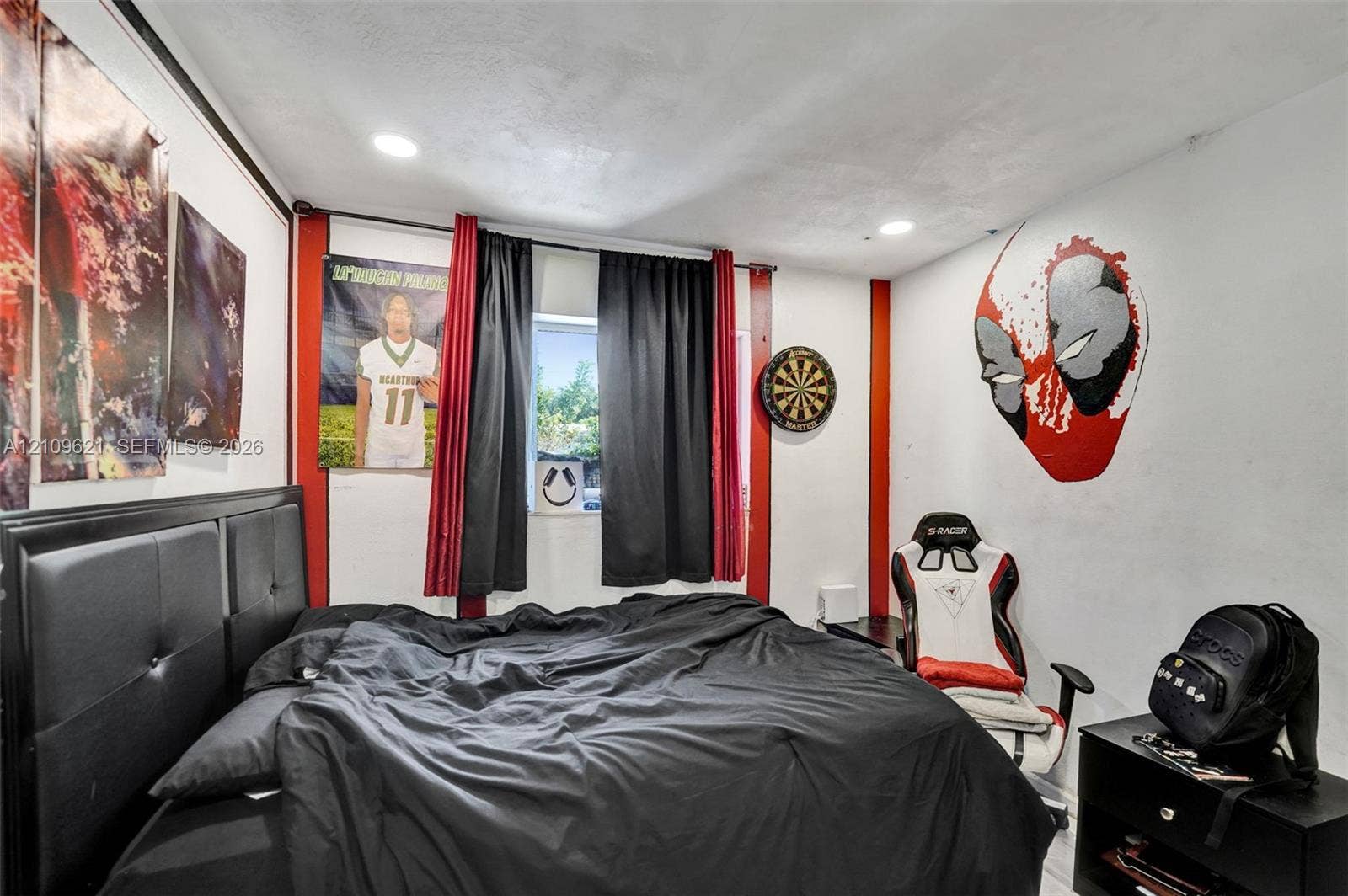 231 SW 64th Way, Pembroke Pines, FL 33023 Bedroom featuring recessed ceiling lighting, red wall accents, and a window with neutral-toned walls