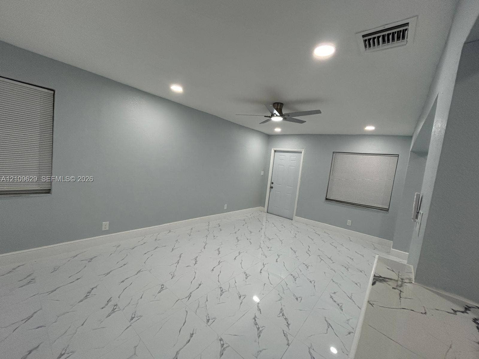 1741 NW 24th Terrace, Fort Lauderdale, FL 33311 Large-format stone-patterned tile flooring, recessed ceiling lighting, and a multi-speed ceiling fan