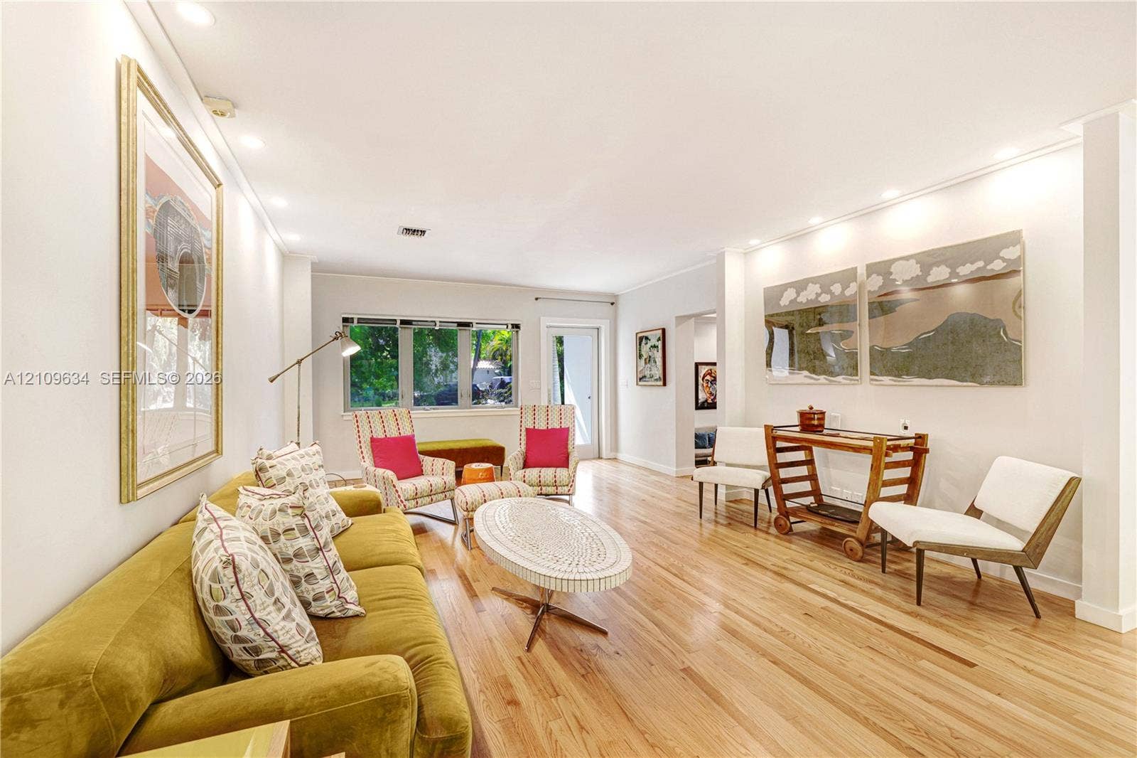 Living area featuring wood-finish flooring, recessed lighting, and expansive windows