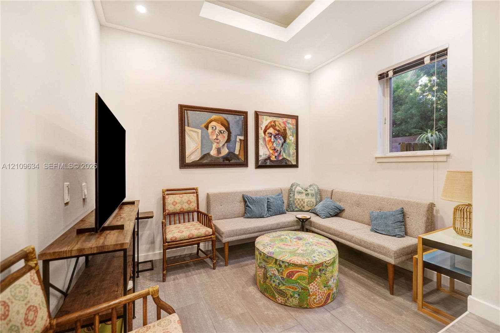 Tray ceiling with recessed lighting and wood-finish flooring