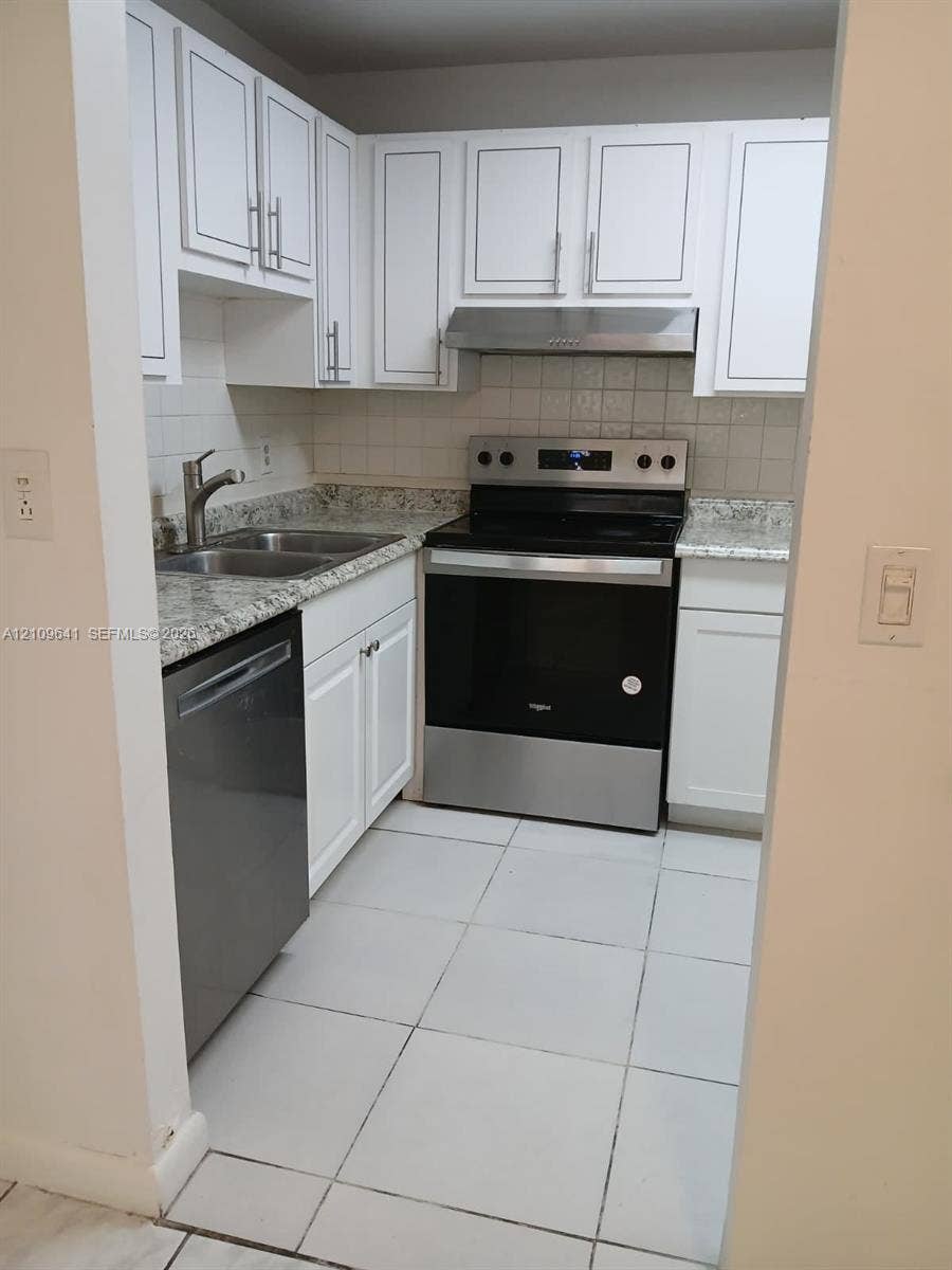 4108 NW 88th Avenue, #4, Coral Springs, Coral Springs, FL 33065 Kitchen featuring white cabinetry, stone-finish countertops, stainless steel appliances, a double-basin sink, and tile flooring