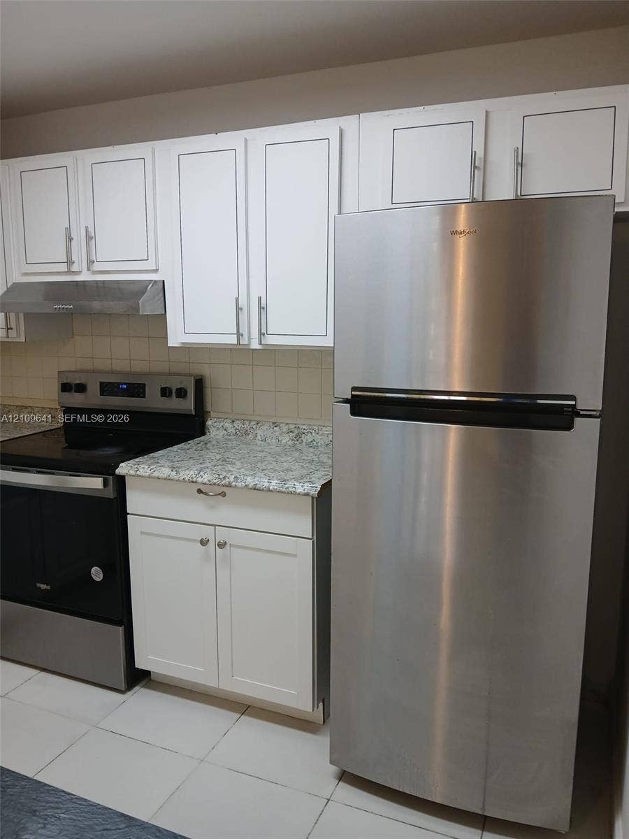 4108 NW 88th Avenue, #4, Coral Springs, Coral Springs, FL 33065 Kitchen featuring white shaker-style cabinetry, stone-finish countertops, stainless steel appliances, and a square-tile backsplash