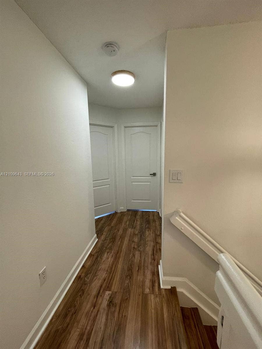11467 NW 51st Terrace, Doral, Doral, FL 33178 Wood-finish flooring, white paneled interior doors, and a neutral color palette featuring a ceiling-mounted light fixture