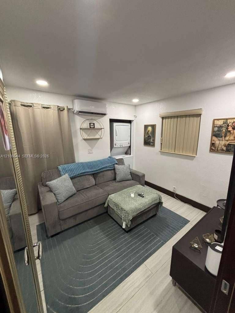 1881 SW 42nd Terrace, #2, Fort Lauderdale, Fort Lauderdale, FL 33317 Interior space featuring recessed lighting, light-toned wood-finish flooring, a wall-mounted ductless mini-split system, and a built-in stackable laundry unit