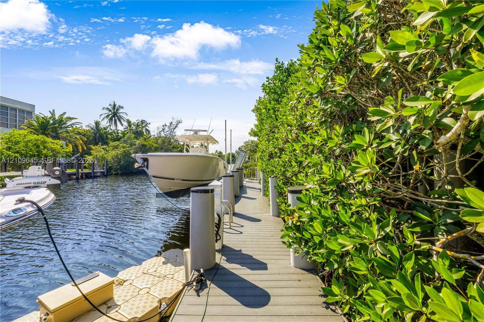 332 Costanera Road, Coral Gables, FL 33143 Waterfront dock featuring composite decking, vertical pilings, and a floating platform