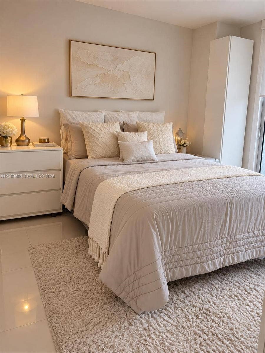 Large-format tile flooring and tall, built-in floor-to-ceiling storage cabinetry
