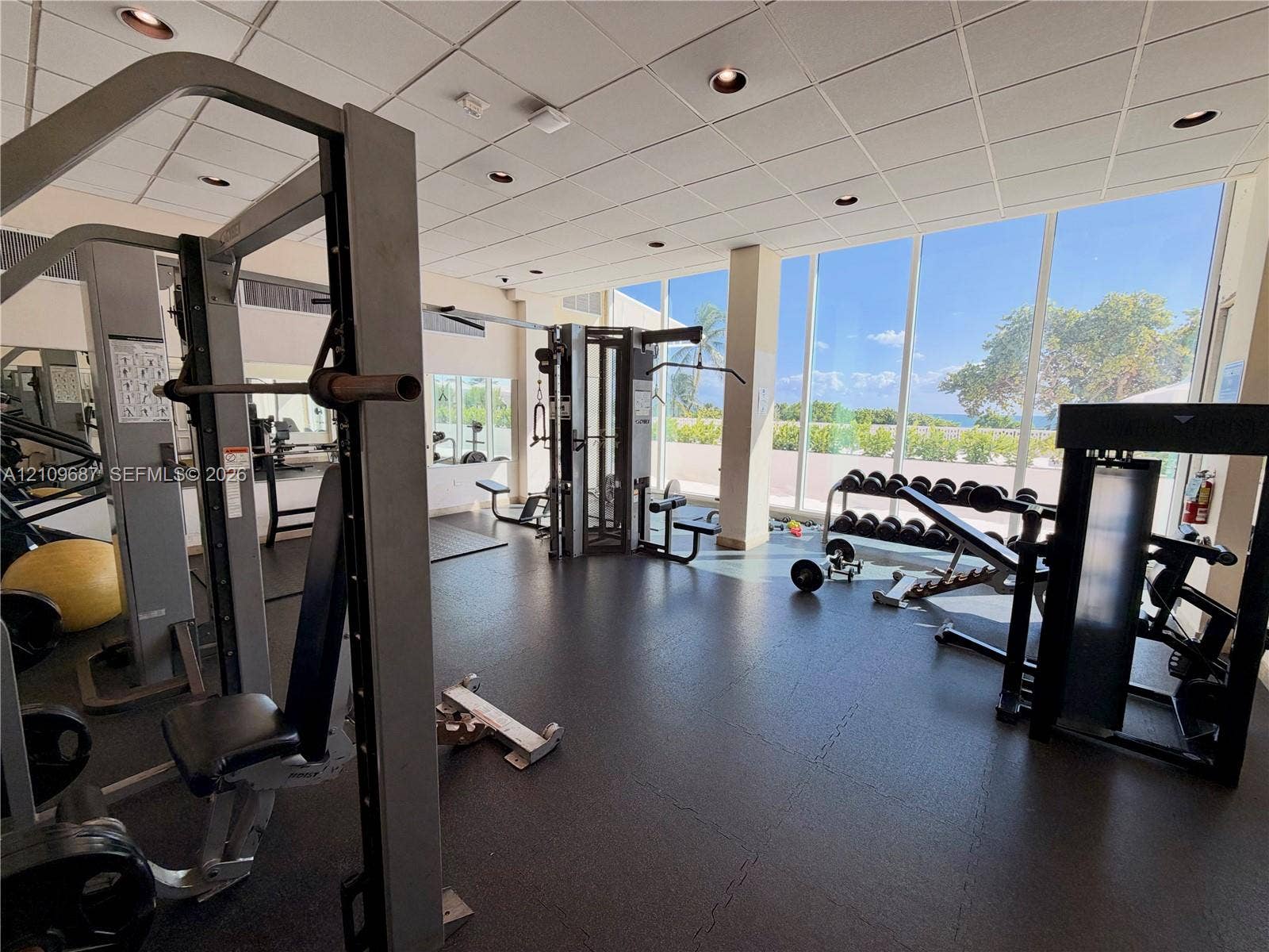 5555 Collins Avenue, #5C, Miami Beach, FL 33140 Fitness center featuring floor-to-ceiling windows, rubberized flooring, and recessed ceiling lighting