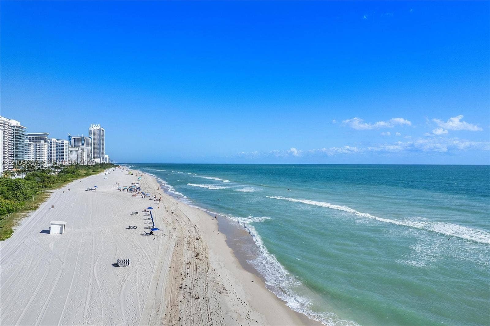 5555 Collins Avenue, #5C, Miami Beach, FL 33140 Coastal landscape featuring an expansive sandy shoreline and ocean waves