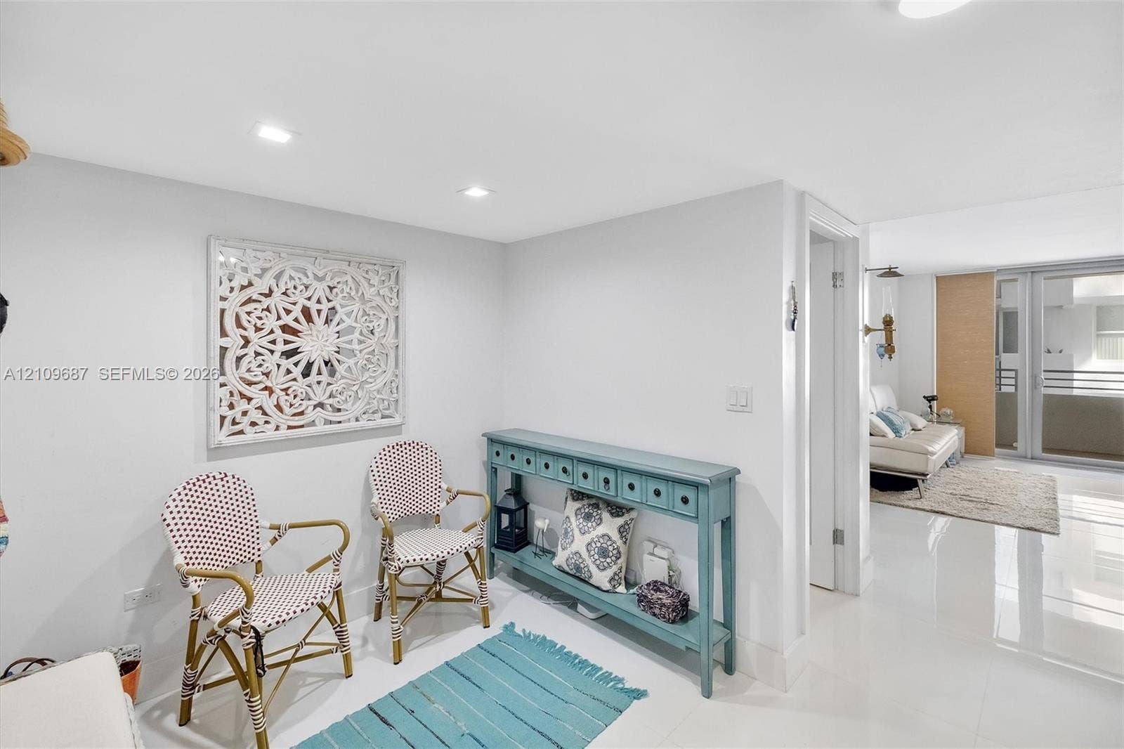 5555 Collins Avenue, #5C, Miami Beach, FL 33140 Polished tile flooring, recessed ceiling lighting, and glass-paneled patio doors