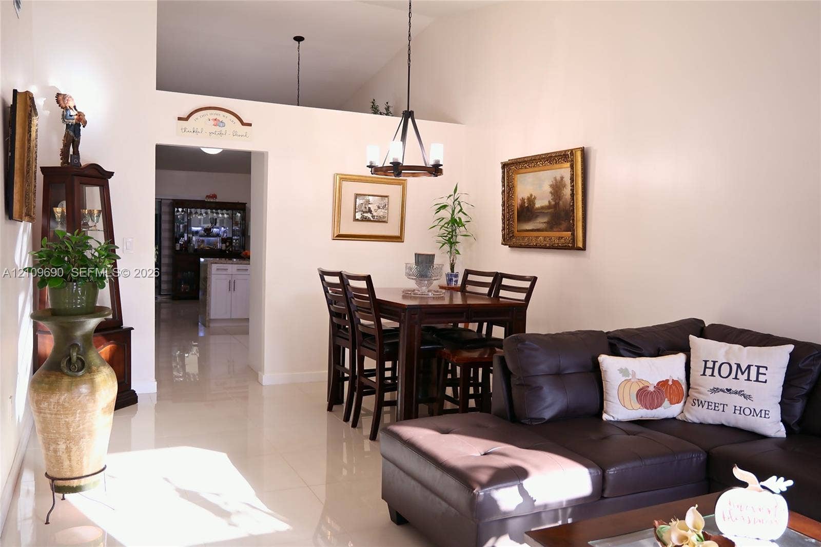 Vaulted ceilings, large-format tile flooring, and a multi-arm suspended chandelier