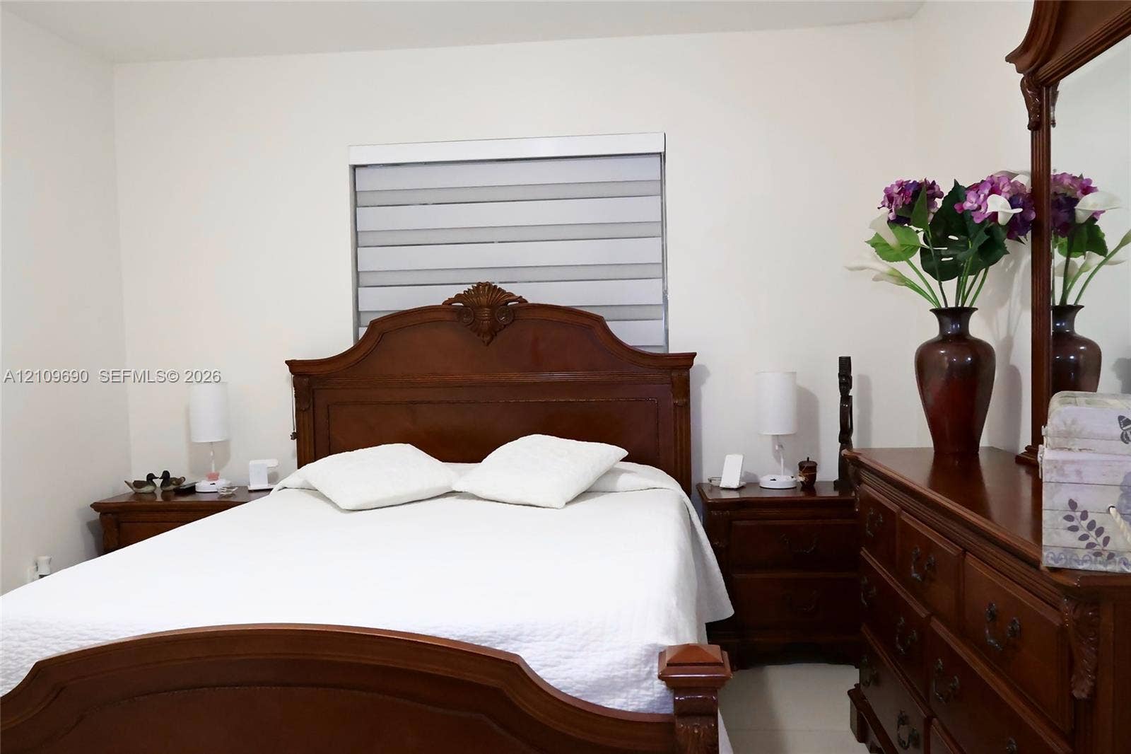 Neutral wall finishes and a dual-shade roller window treatment