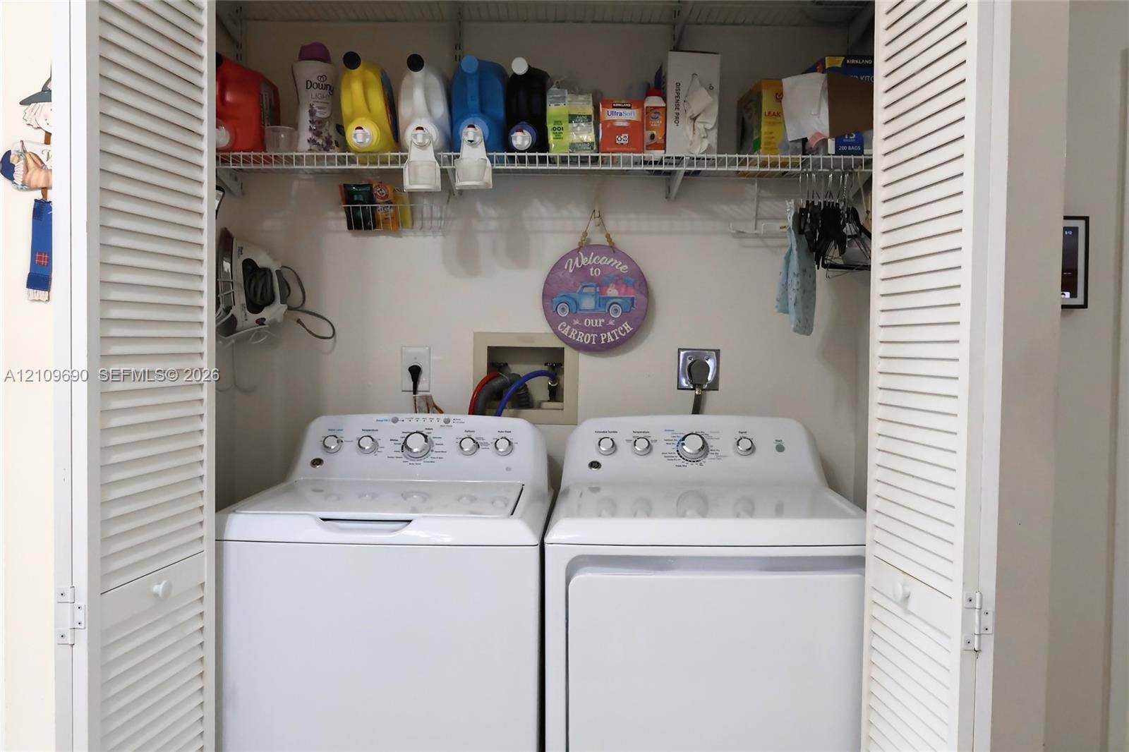 Laundry closet featuring bi-fold louvered doors and wire shelving