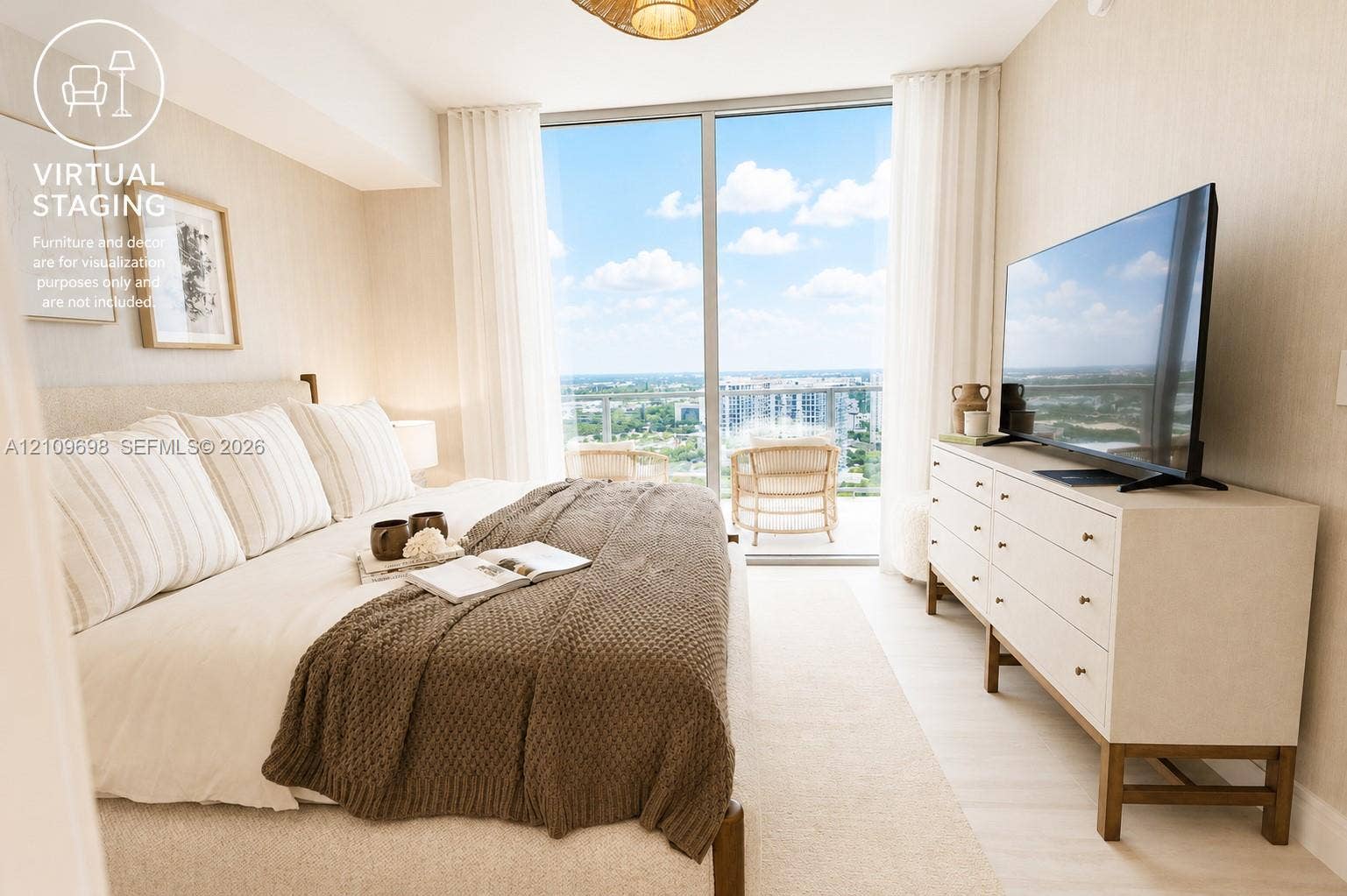 2411 Laguna Circle, #810, North Miami, FL 33181 Floor-to-ceiling glass sliding doors, light-toned wide-plank flooring, and a private balcony with an expansive exterior landscape