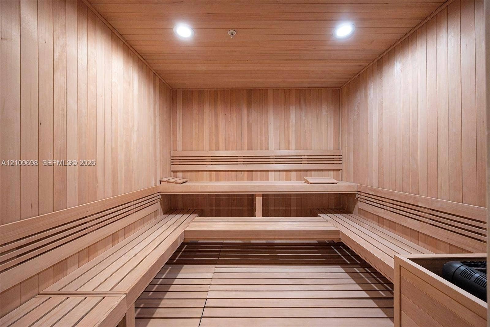 2411 Laguna Circle, #810, North Miami, FL 33181 Sauna featuring natural wood-paneled walls, multi-level built-in bench seating, recessed lighting, and a slatted wood floor