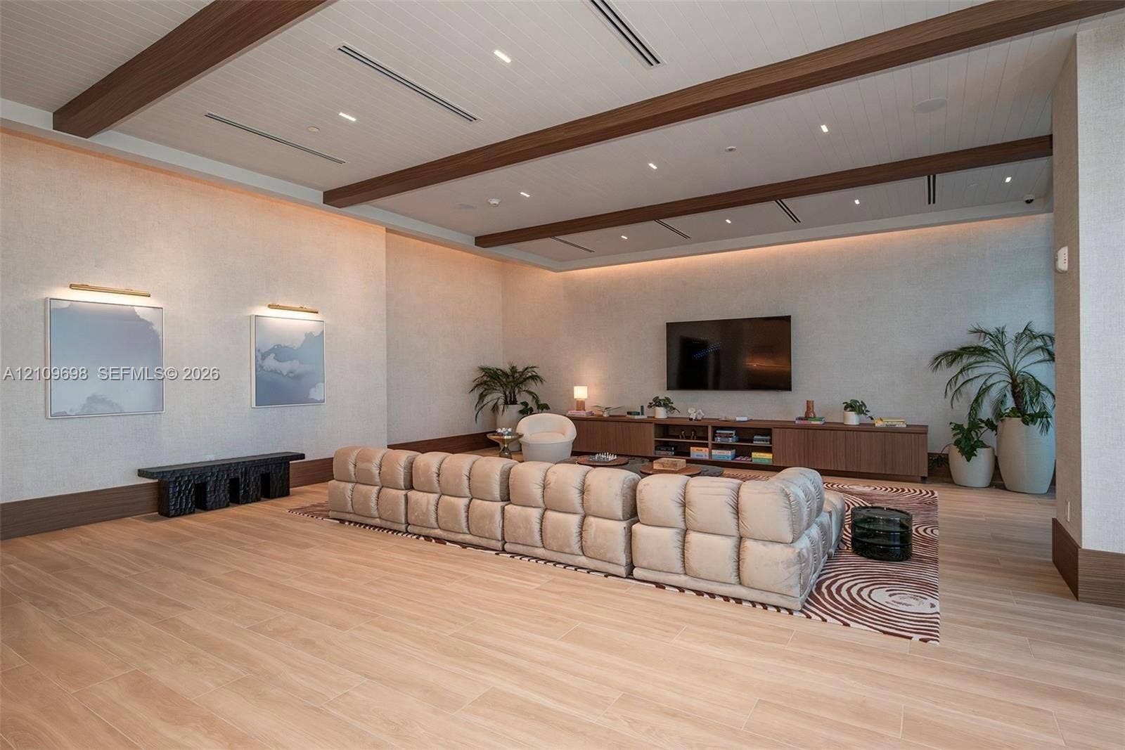 2411 Laguna Circle, #810, North Miami, FL 33181 Recessed lighting, wood-finish ceiling beams, wood-finish flooring, built-in media console, and wall-mounted art lighting