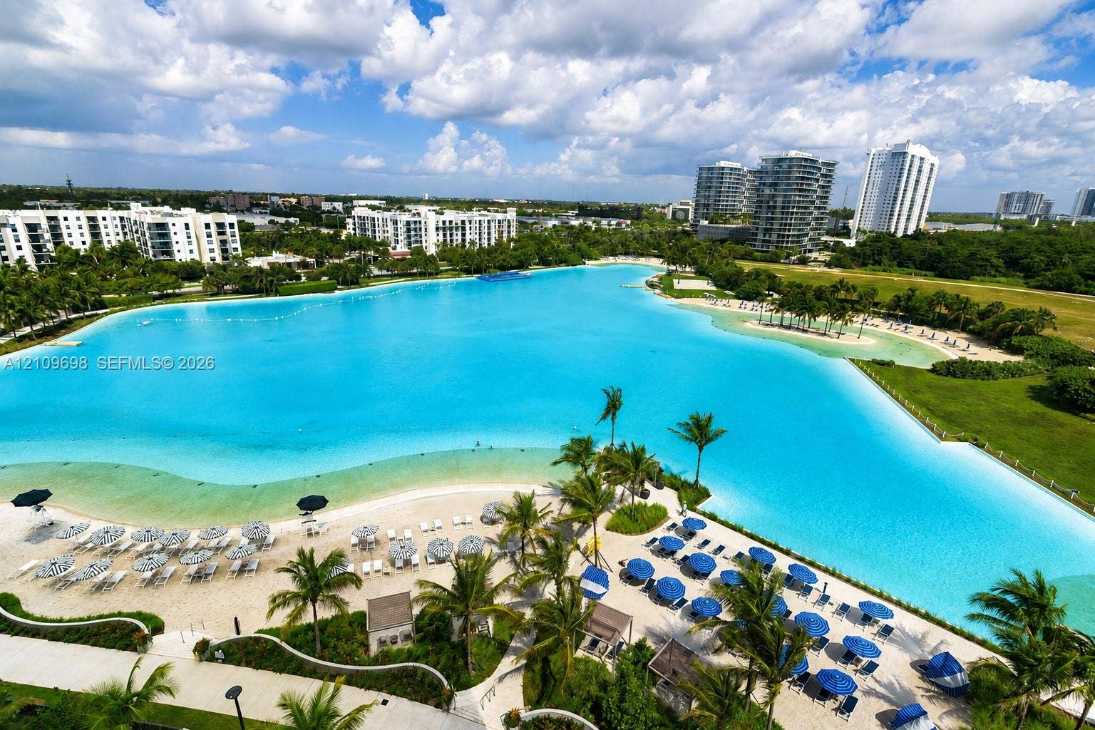 2411 Laguna Circle, #810, North Miami, FL 33181 Expansive man-made lagoon featuring sandy beaches, mature palm trees, and manicured landscaping