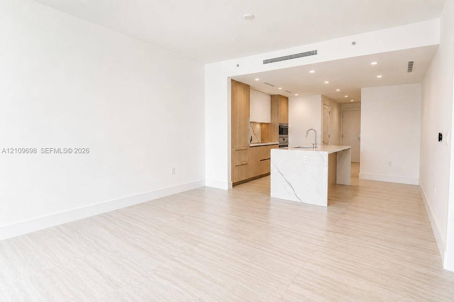 2411 Laguna Circle, #810, North Miami, FL 33181 Open-concept space with light-toned wood-finish flooring and recessed ceiling lighting