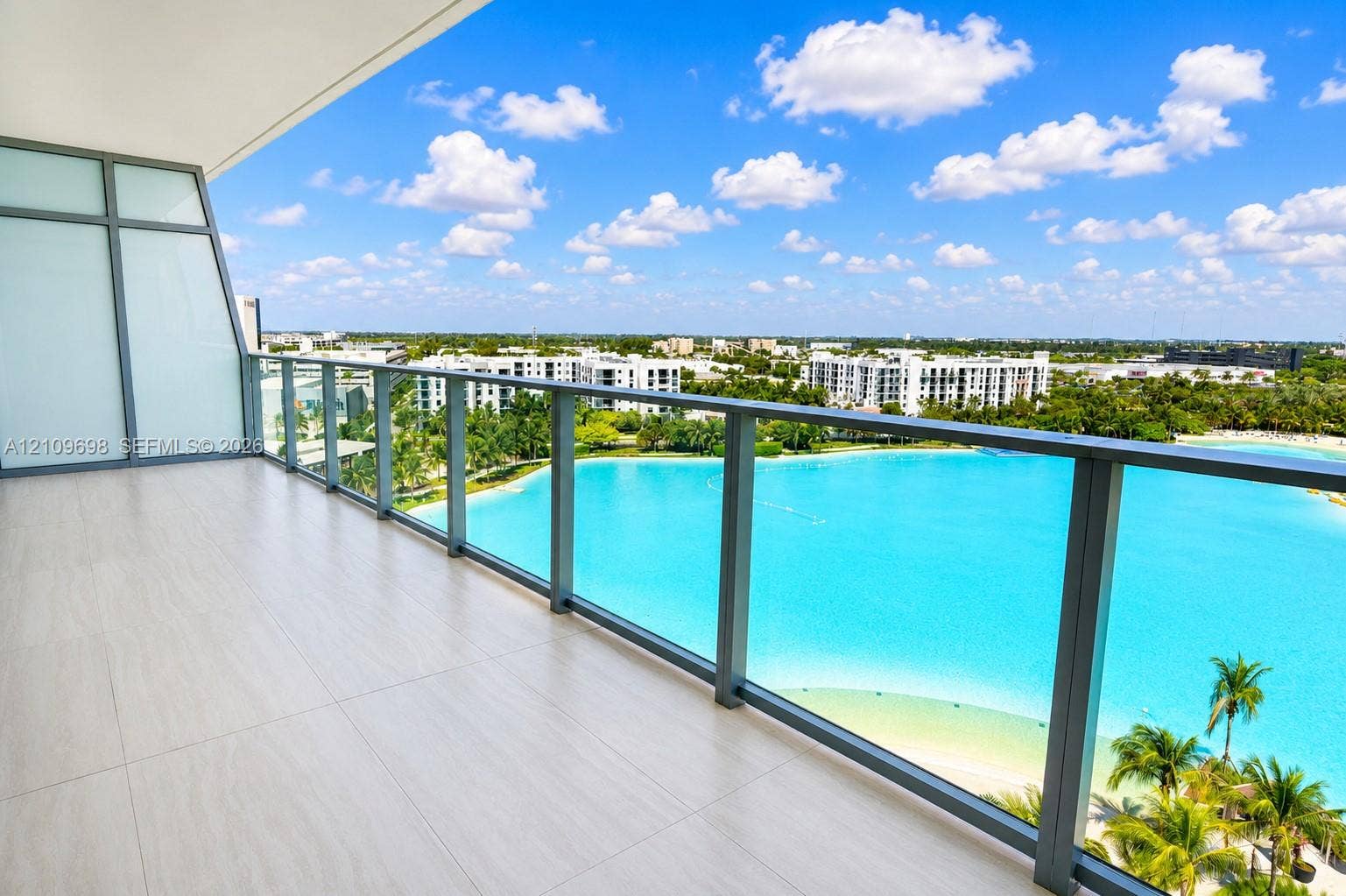 2411 Laguna Circle, #810, North Miami, FL 33181 Covered balcony featuring tile flooring and a glass-paneled metal railing