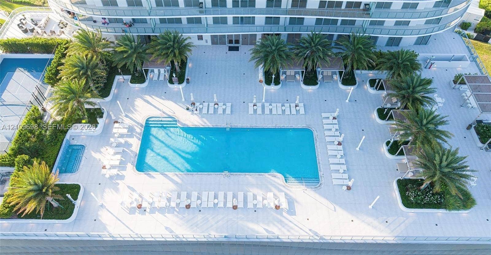 2411 Laguna Circle, #810, North Miami, FL 33181 Swimming pool with an integrated spa, paved sun deck, and mature palm landscaping