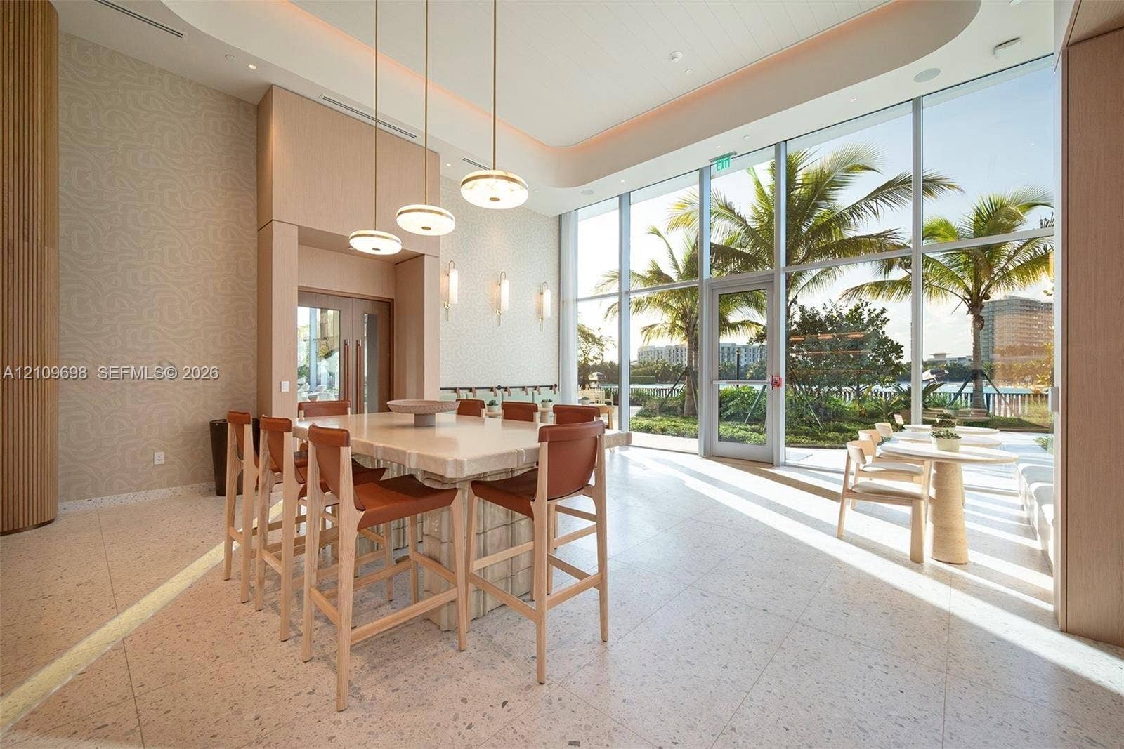 2411 Laguna Circle, #810, North Miami, FL 33181 Floor-to-ceiling windows, stone-finish tile flooring, recessed tray ceiling, pendant lighting, and a built-in stone island