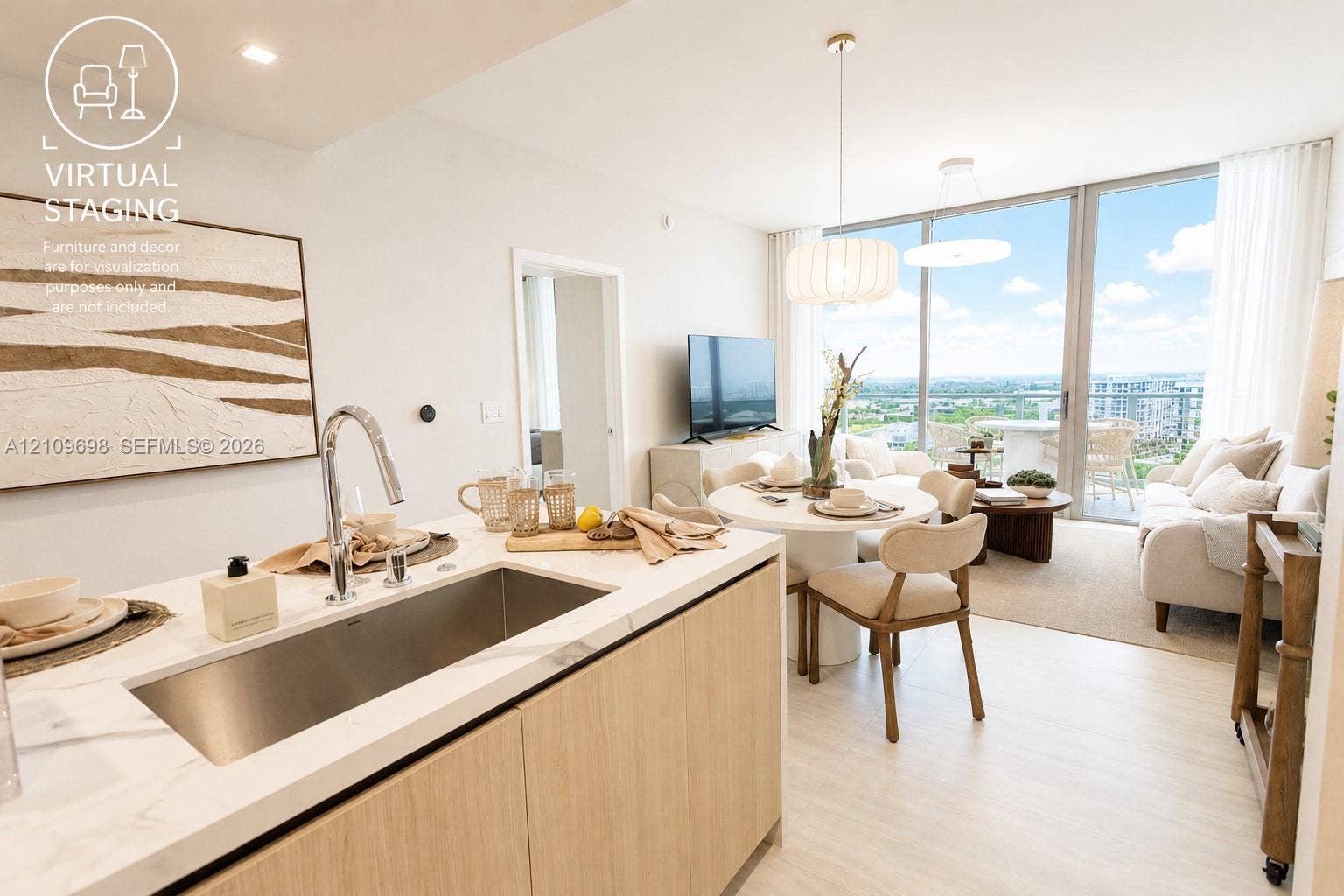 2411 Laguna Circle, #810, North Miami, FL 33181 Open-concept kitchen featuring an integrated stainless steel basin sink, stone-surface countertop, and wood-finish cabinetry