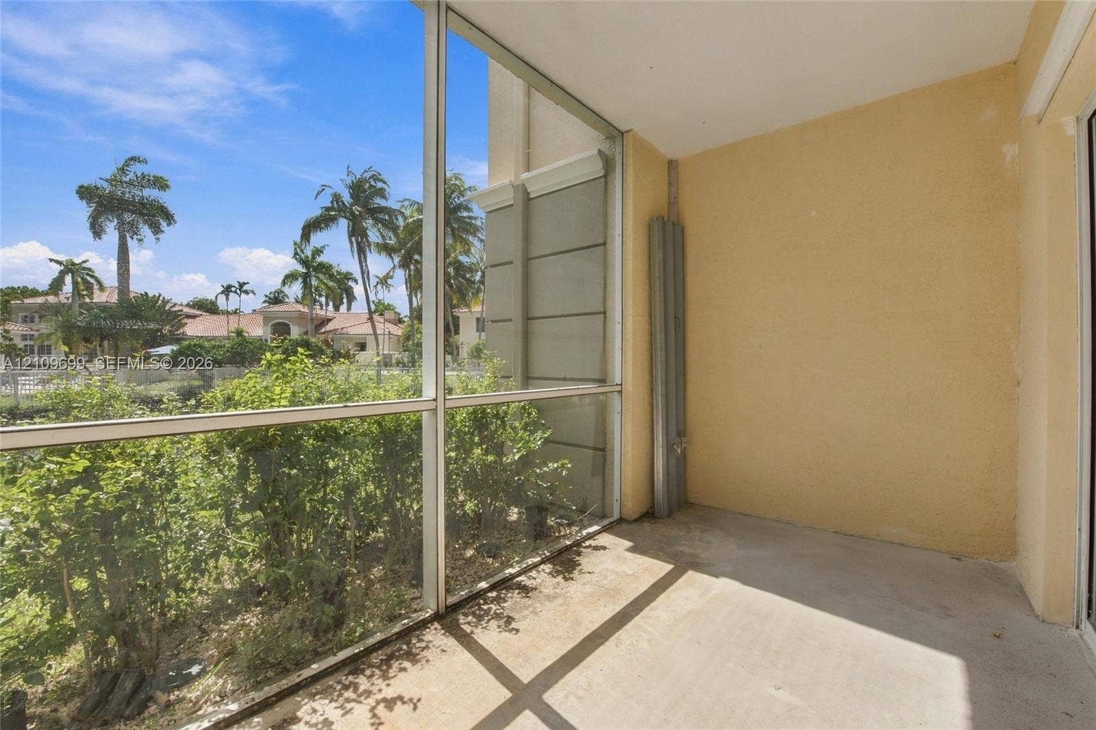 Screened-in lanai featuring concrete flooring and aluminum framing