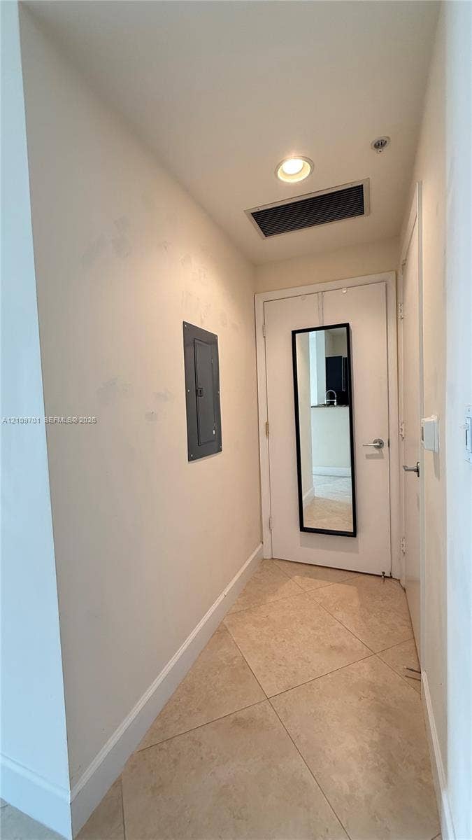 Diagonal-set stone flooring and recessed ceiling lighting