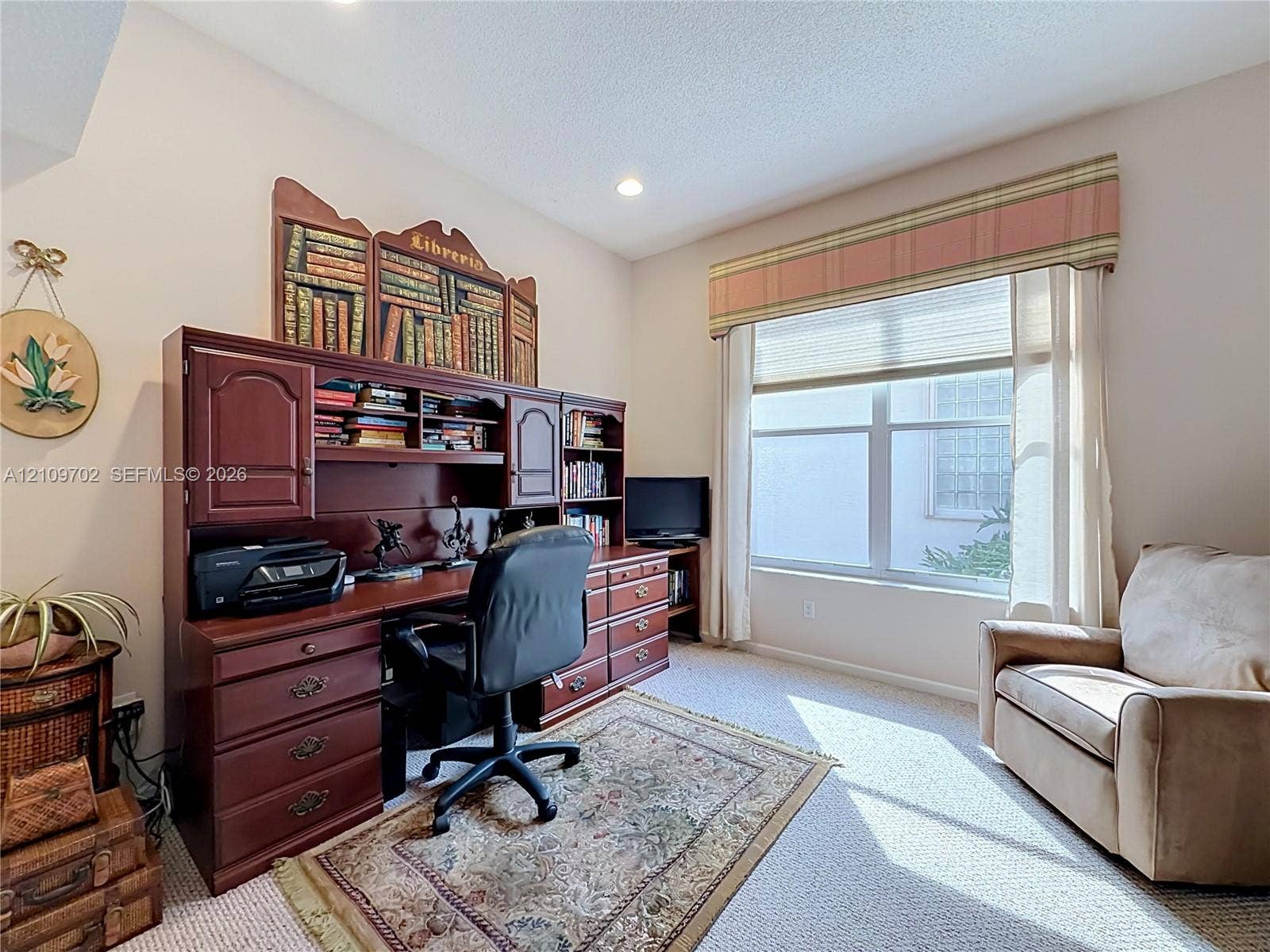 Interior space featuring recessed lighting, carpeting, and a large window with a top-mounted valance