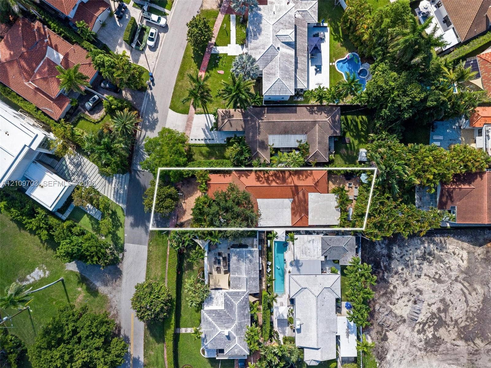 421 W 62nd Street, Miami Beach, FL 33140 Aerial perspective of property featuring a tile roof, mature landscape, and hardscaped patio areas