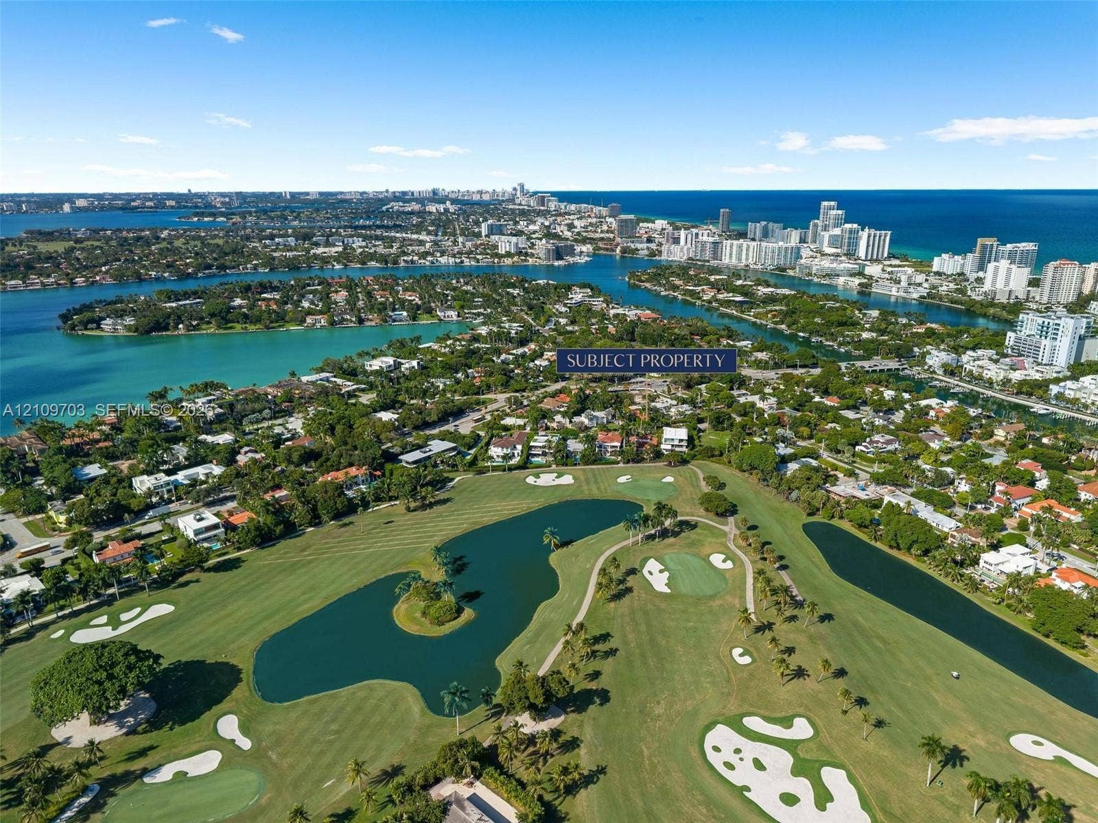 421 W 62nd Street, Miami Beach, FL 33140 Aerial perspective featuring a waterfront setting, proximity to coastal waterways, and expansive golf course grounds