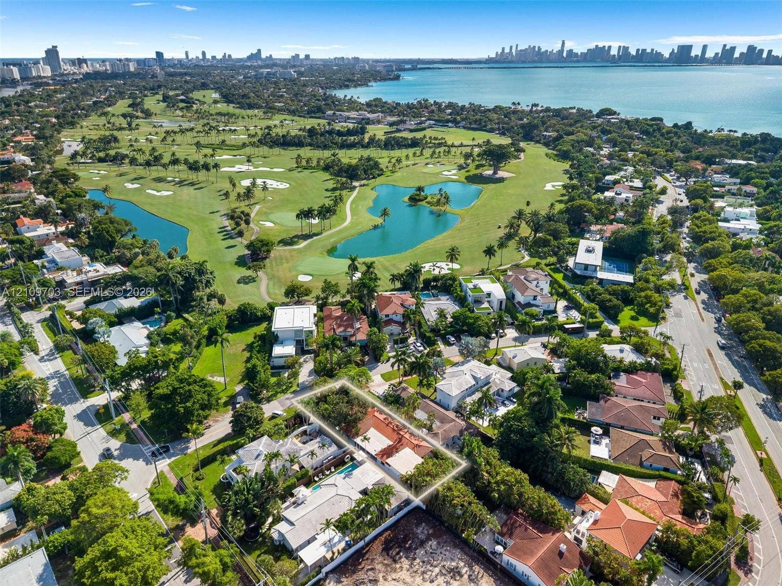 421 W 62nd Street, Miami Beach, FL 33140 Aerial perspective of property featuring a multi-pitched roofline and mature perimeter landscaping