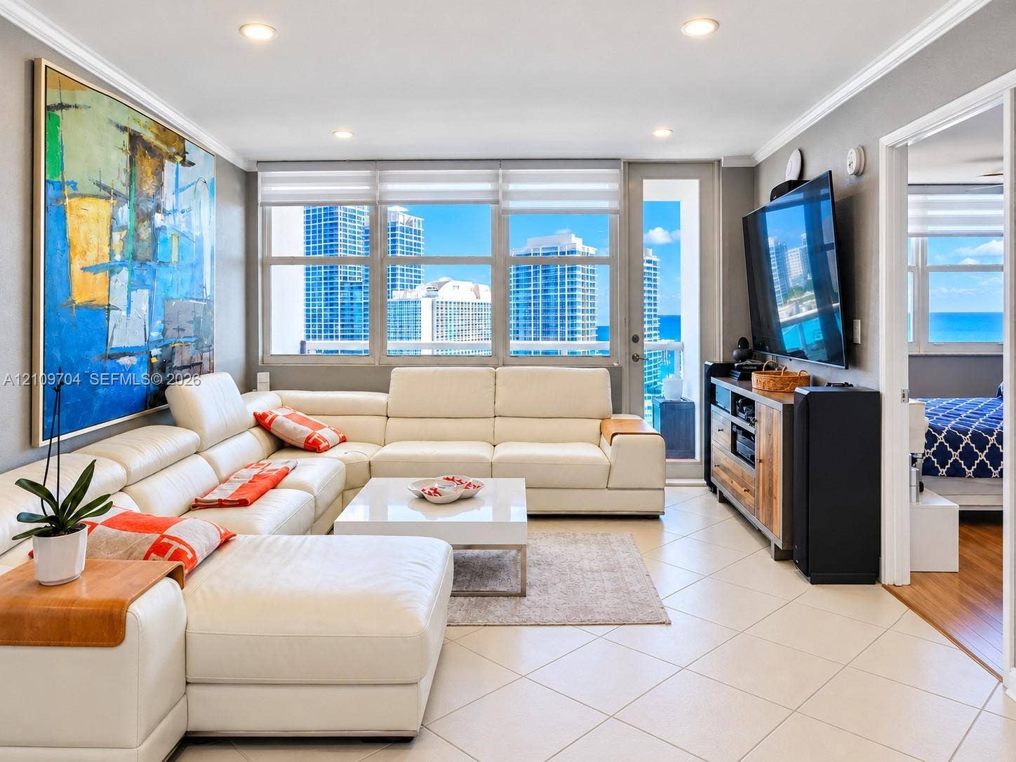 6770 Indian Creek Drive, #14C, Miami Beach, FL 33141 Living area featuring large format tile flooring, recessed ceiling lighting, and floor-to-ceiling windows with panoramic city and coastal scenery