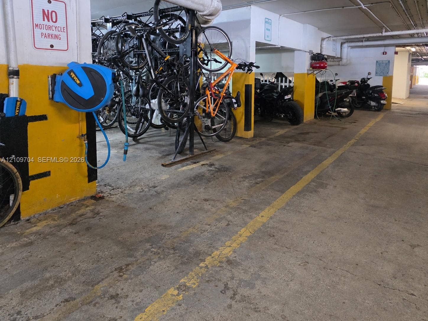 6770 Indian Creek Drive, #14C, Miami Beach, FL 33141 Covered parking garage featuring dedicated bicycle storage racks and painted floor markings