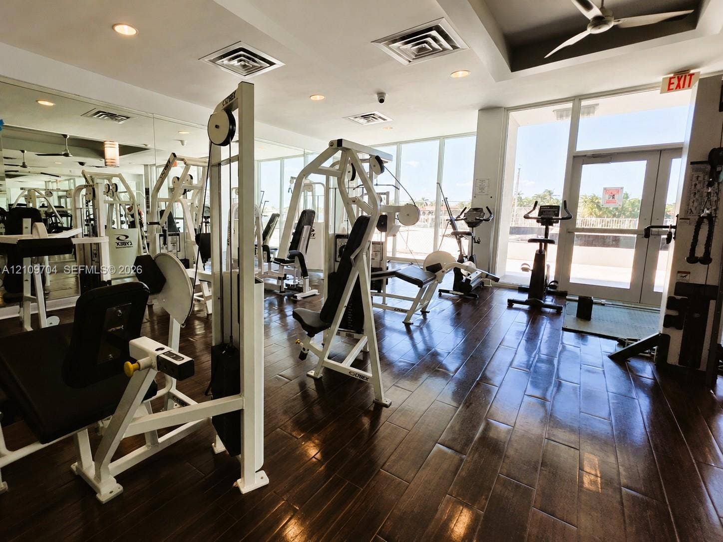 6770 Indian Creek Drive, #14C, Miami Beach, FL 33141 Fitness center featuring floor-to-ceiling windows, wood-finish flooring, recessed lighting, and mirrored walls