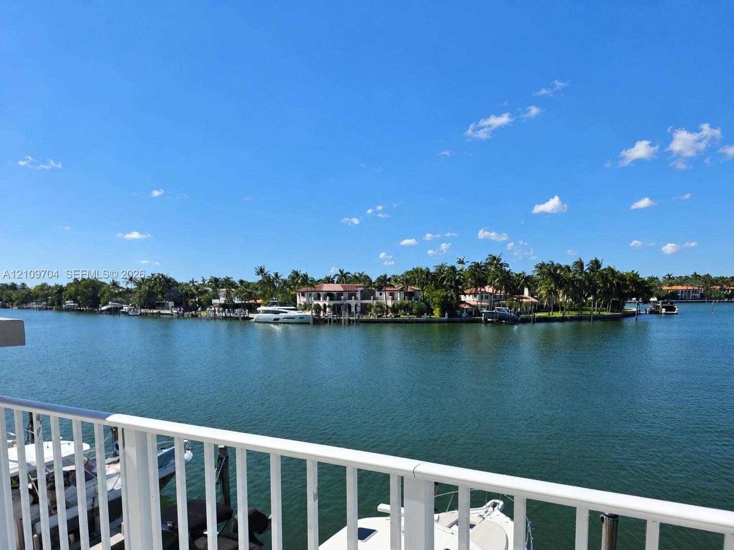 6770 Indian Creek Drive, #14C, Miami Beach, FL 33141 Waterfront property featuring a private boat slip, white metal railing, and direct waterway access