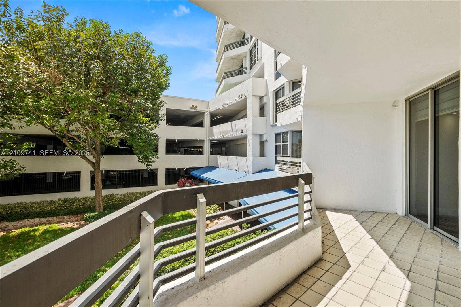 19101 NE 36th Court, #203, Aventura, FL 33180 Covered balcony featuring tile flooring and a horizontal metal railing