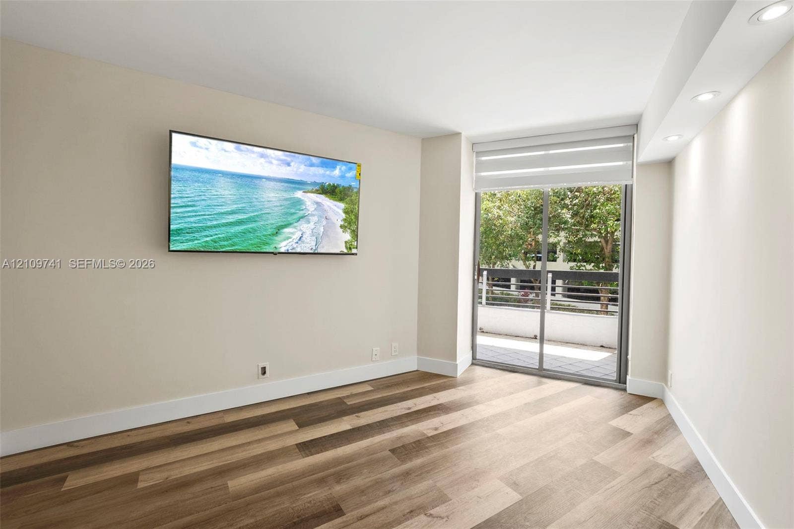 19101 NE 36th Court, #203, Aventura, FL 33180 Interior space featuring wood-finish flooring, recessed lighting, and a sliding glass door providing external access