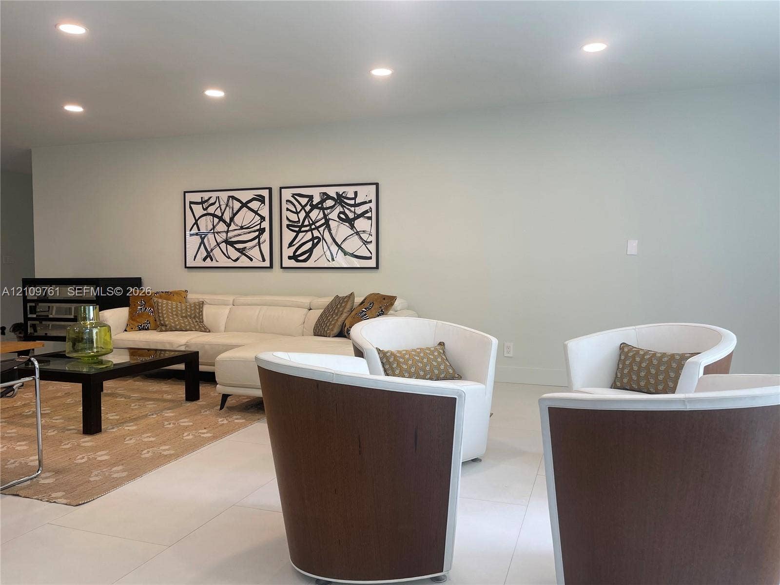 Neutral-toned interior featuring large-format tile flooring and recessed ceiling lighting
