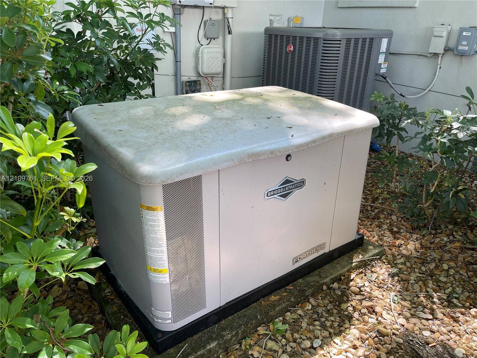 Permanent whole-home standby generator and exterior central air conditioning unit
