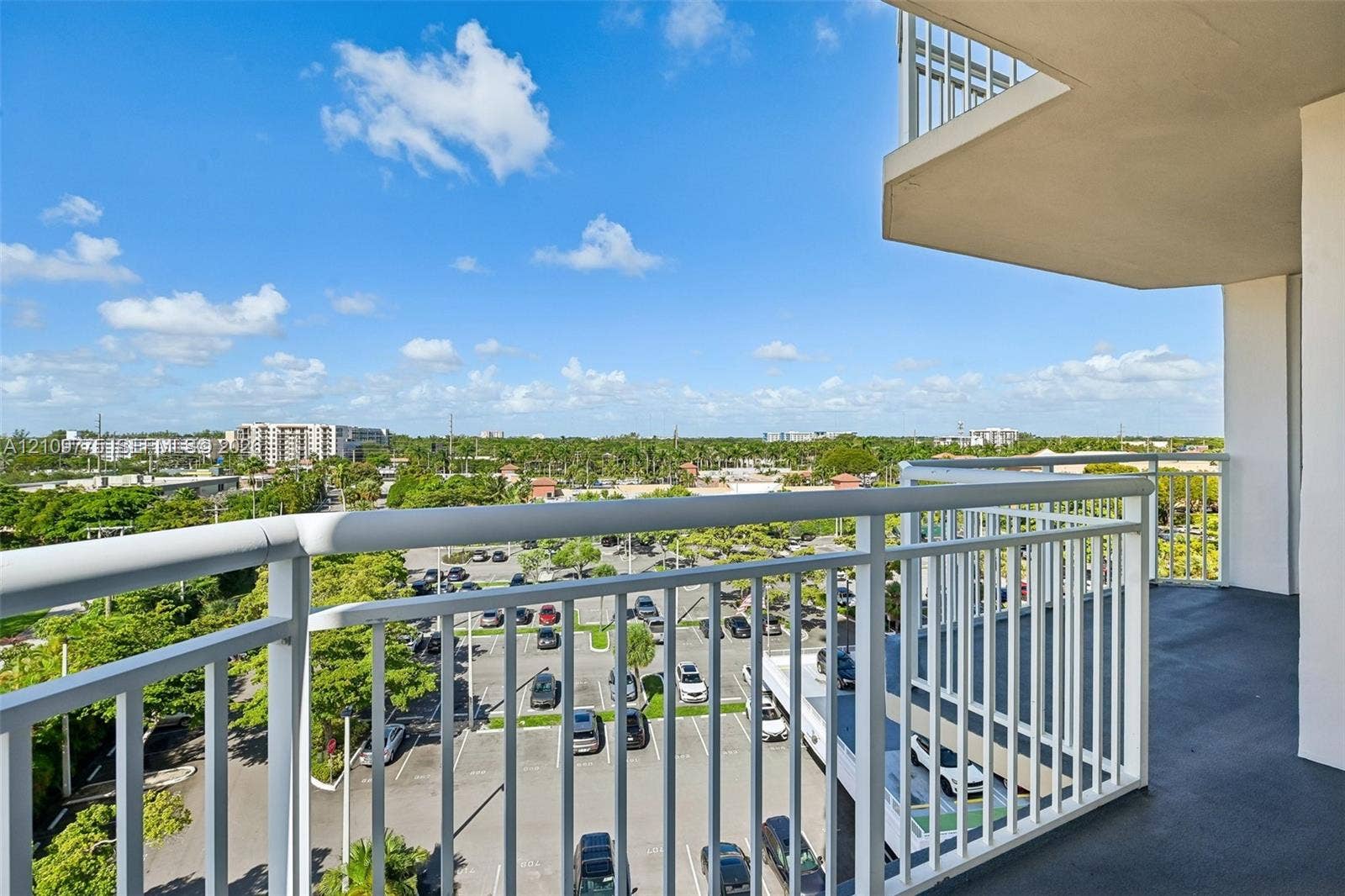 Covered balcony featuring white metal railings and solid flooring