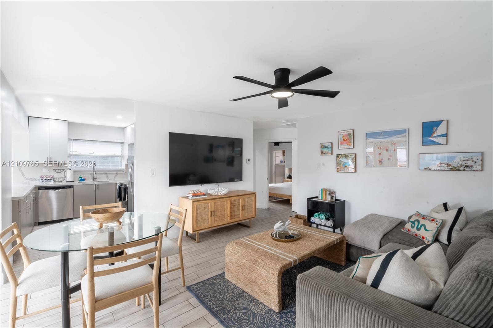 1469 NW 10th Street, #1471, Dania, Dania Beach, FL 33004 Open-concept living space featuring wood-finish tile flooring, recessed ceiling lighting, a matte black multi-blade ceiling fan, and neutral wall tones