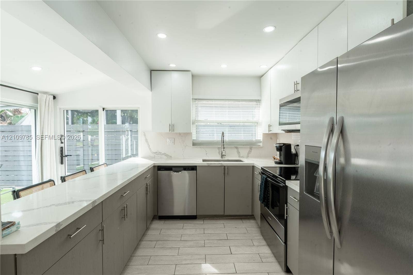 1469 NW 10th Street, #1471, Dania, Dania Beach, FL 33004 Kitchen featuring stone-finish countertops, stainless steel appliances, flat-panel cabinetry, and tile flooring