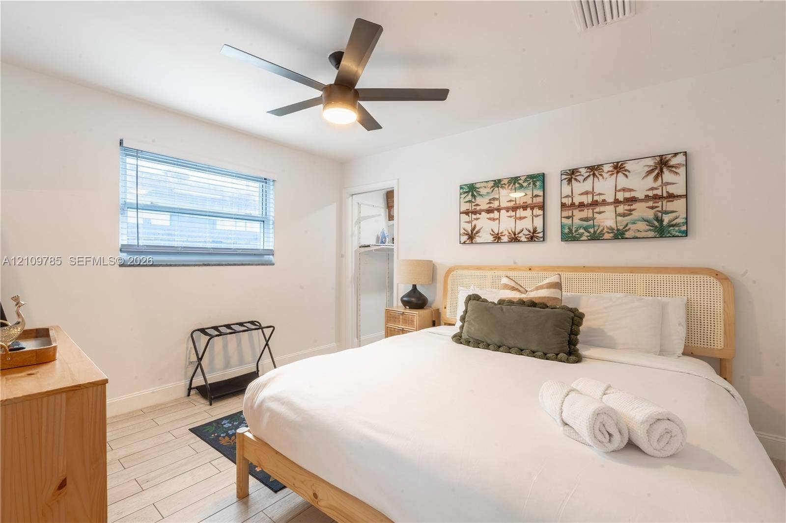 1469 NW 10th Street, #1471, Dania, Dania Beach, FL 33004 Room featuring white walls, light-toned wood-finish flooring, a multi-blade ceiling fan with integrated lighting, and a horizontal window with blinds